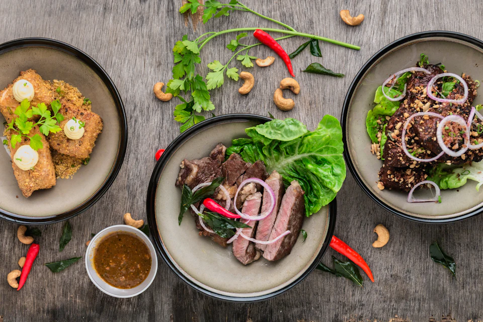 Plated dishes with fresh herbs on a rustic table